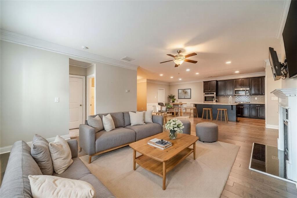 347 Villa Park Circle Stone Mountain, GA 30087 - Photo 6 of 25 a living room with furniture kitchen view and a chandelier