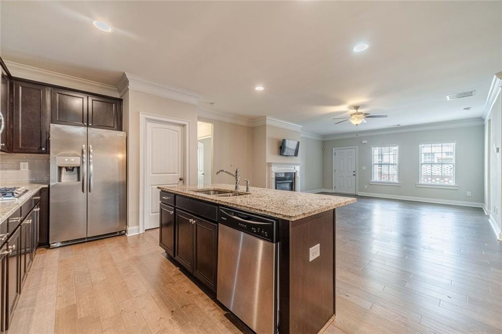 347 Villa Park Circle Stone Mountain, GA 30087 - Photo 8 of 25 a kitchen with stainless steel appliances granite countertop a stove and a refrigerator
