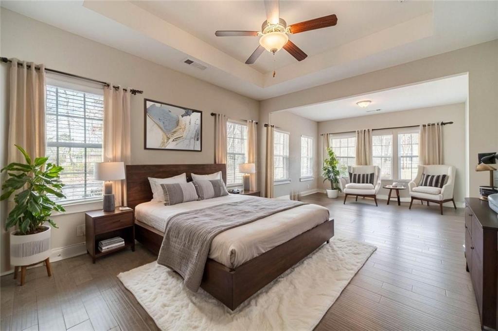 347 Villa Park Circle Stone Mountain, GA 30087 - Photo 9 of 25 a spacious bedroom with a large bed and a couch