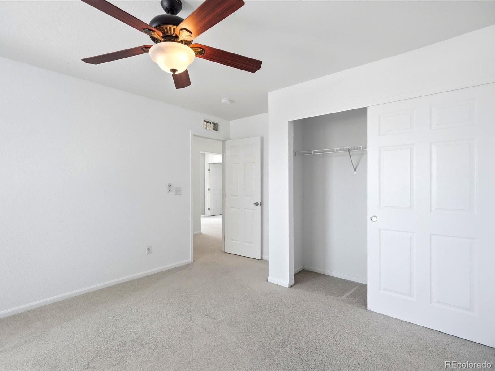 5444 Perth Court Denver, CO 80249 - Photo 33 of 46 an empty room with closet and a ceiling fan