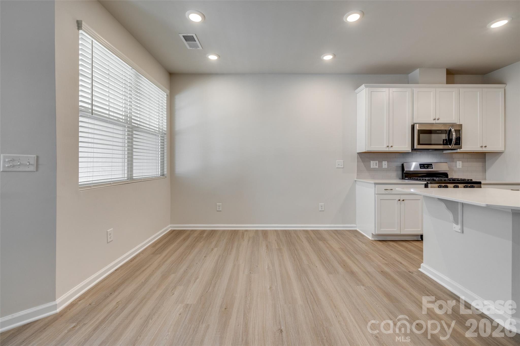 807 Gable Oak Lane Fort Mill, SC 29708 - Photo 10 of 39 a kitchen with granite countertop a stove a sink and a microwave