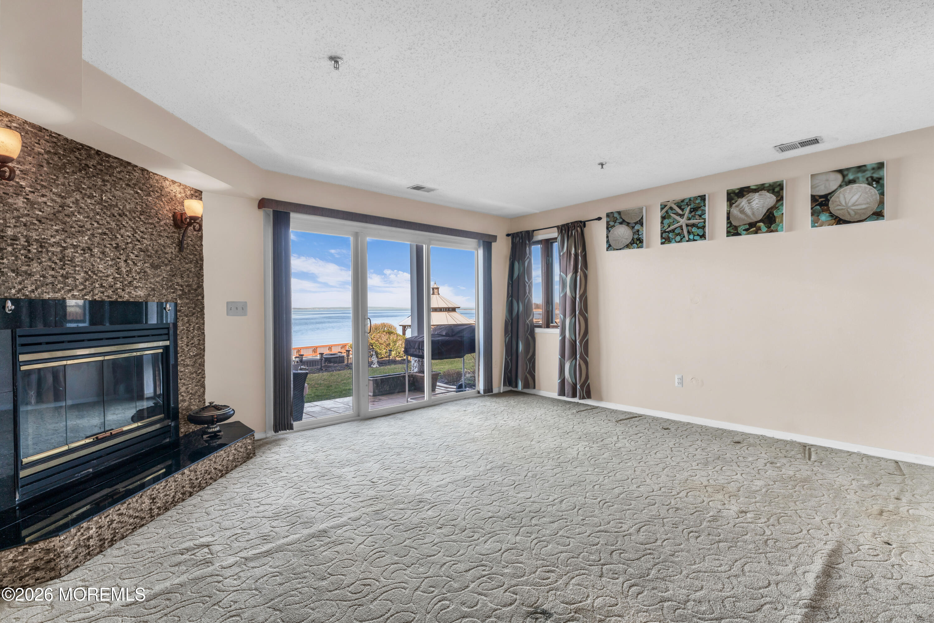 135 1st Street, Unit 1E Keyport, NJ 07735 - Photo 15 of 40 a view of an empty room with a fireplace