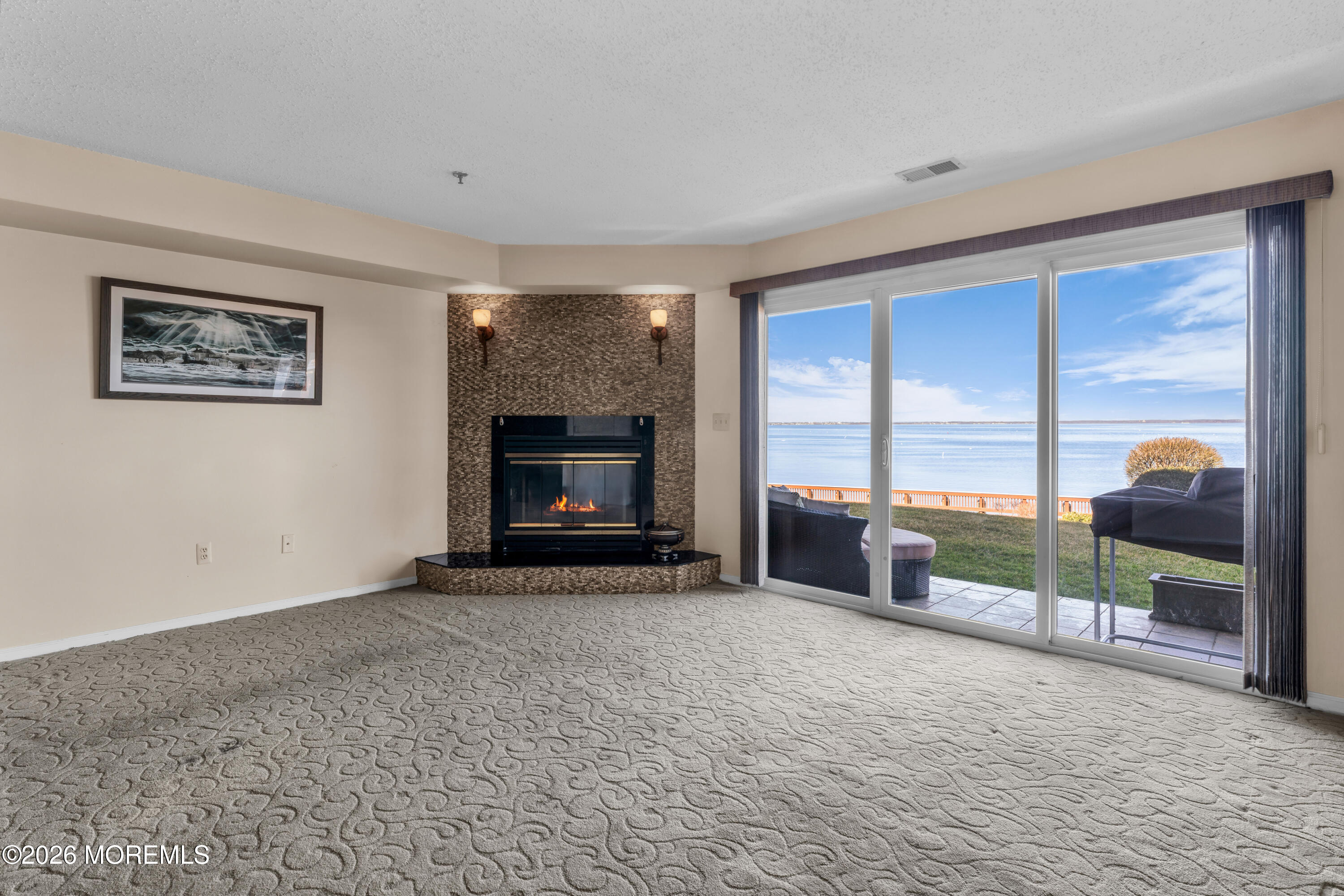 135 1st Street, Unit 1E Keyport, NJ 07735 - Photo 16 of 40 a view of a livingroom with a fireplace and a large window