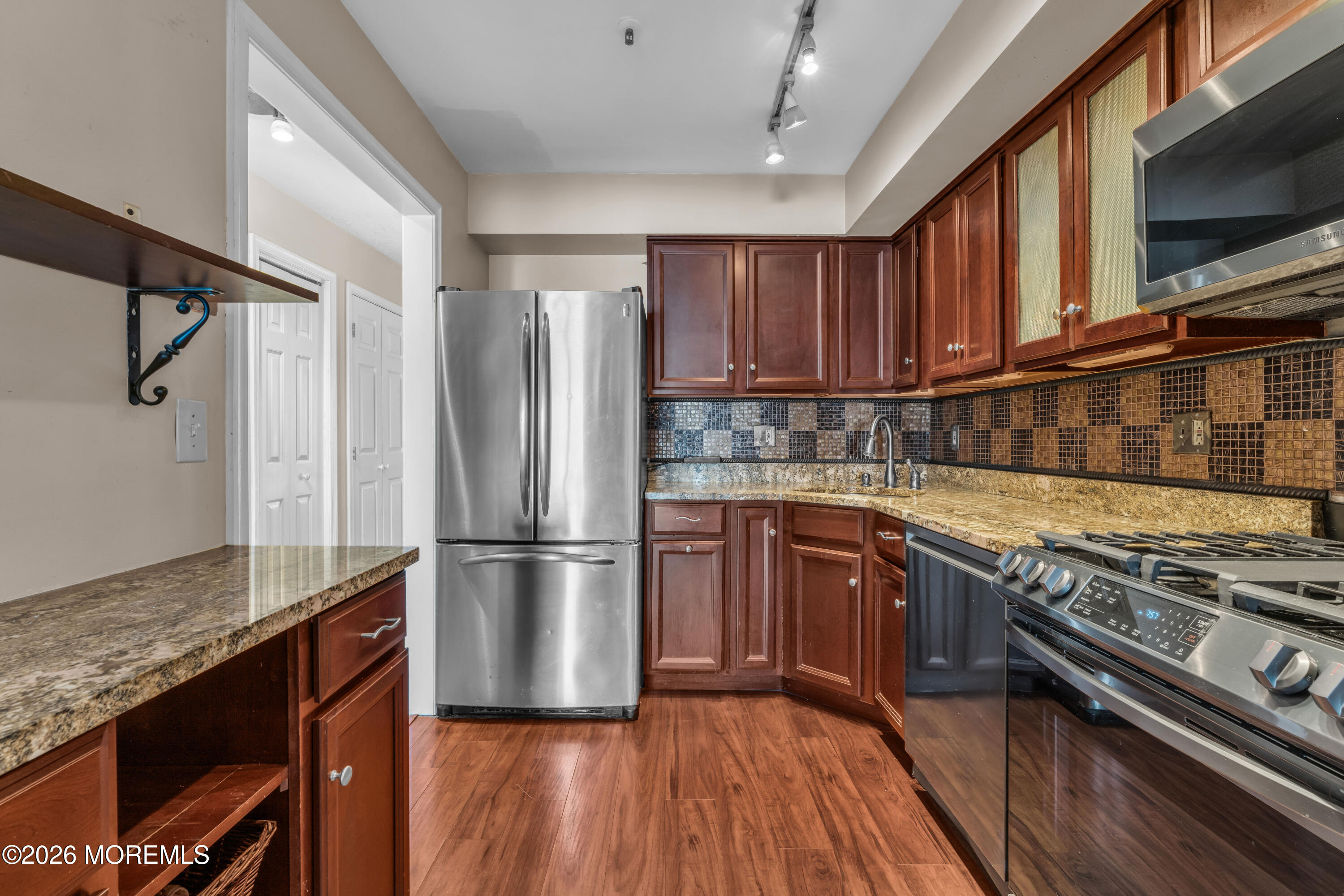 135 1st Street, Unit 1E Keyport, NJ 07735 - Photo 22 of 40 a kitchen with wooden floors and appliances