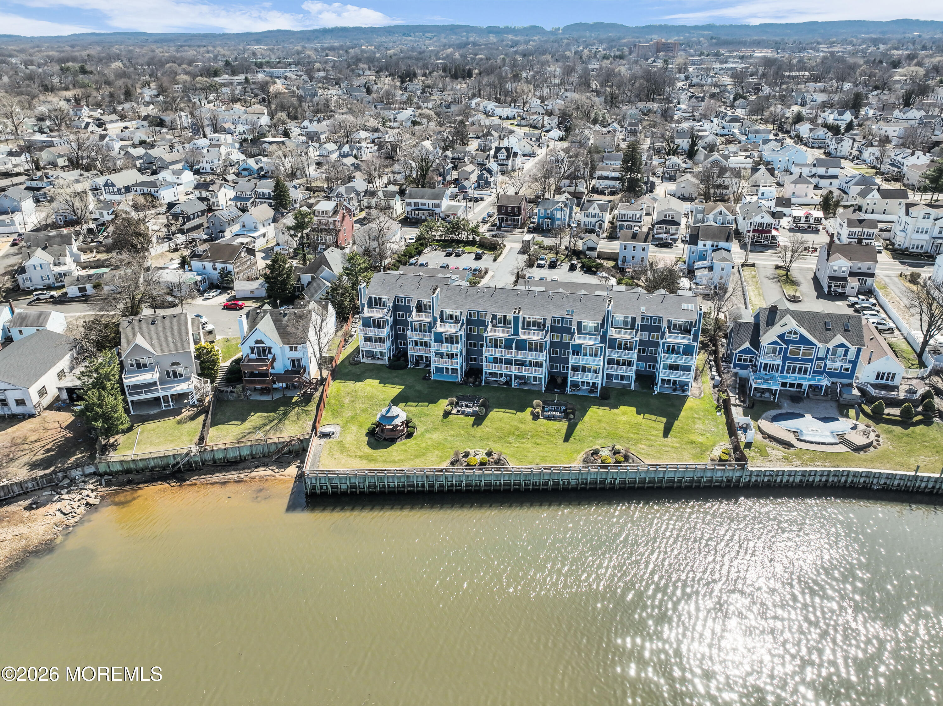 135 1st Street, Unit 1E Keyport, NJ 07735 - Photo 32 of 40 an aerial view of a swimming pool with seating area