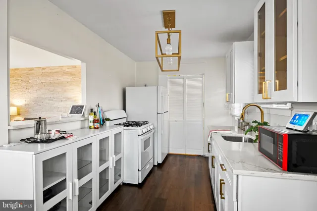 a kitchen with stainless steel appliances a sink a stove and a refrigerator