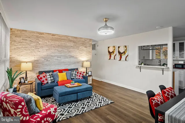 a living room with furniture rug and wooden floor