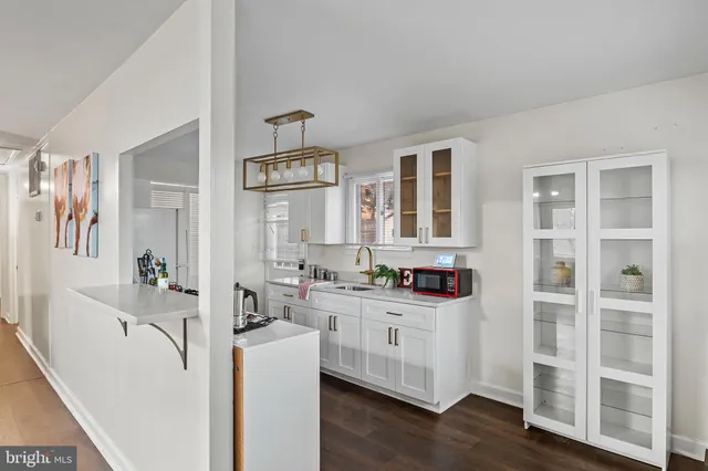 a kitchen with cabinets and wooden floor