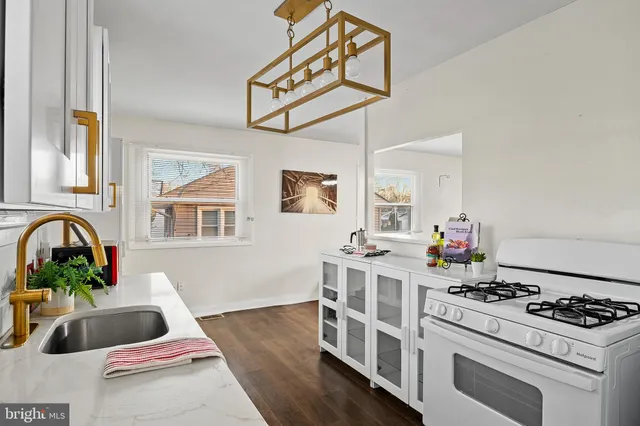 a kitchen with stainless steel appliances a sink stove and cabinets