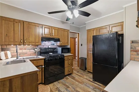 a kitchen with stainless steel appliances sink stove and cabinets