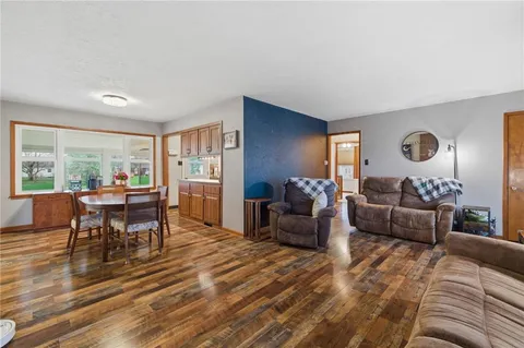 a dining room with furniture and wooden floor