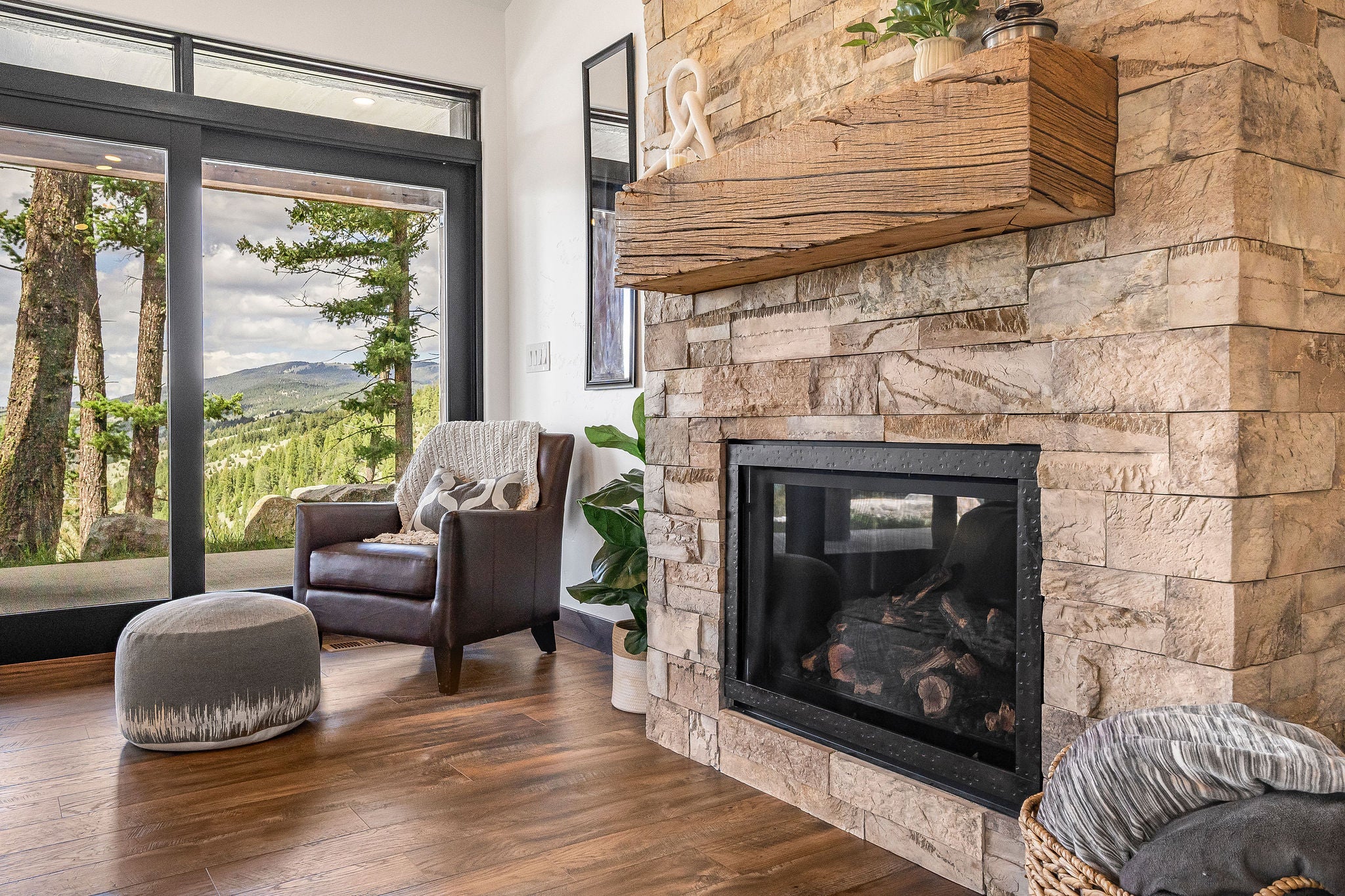 77 Rumsey Road Philipsburg, MT 59858 - Photo 25 of 76 Living area with a stone fireplace and wood finished floors