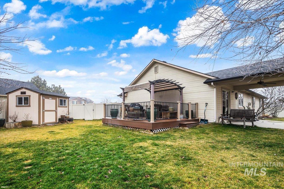 1513 Fairway Street Middleton, ID 83644 - Photo 16 of 20 Rear view of house featuring a deck and a storage unit