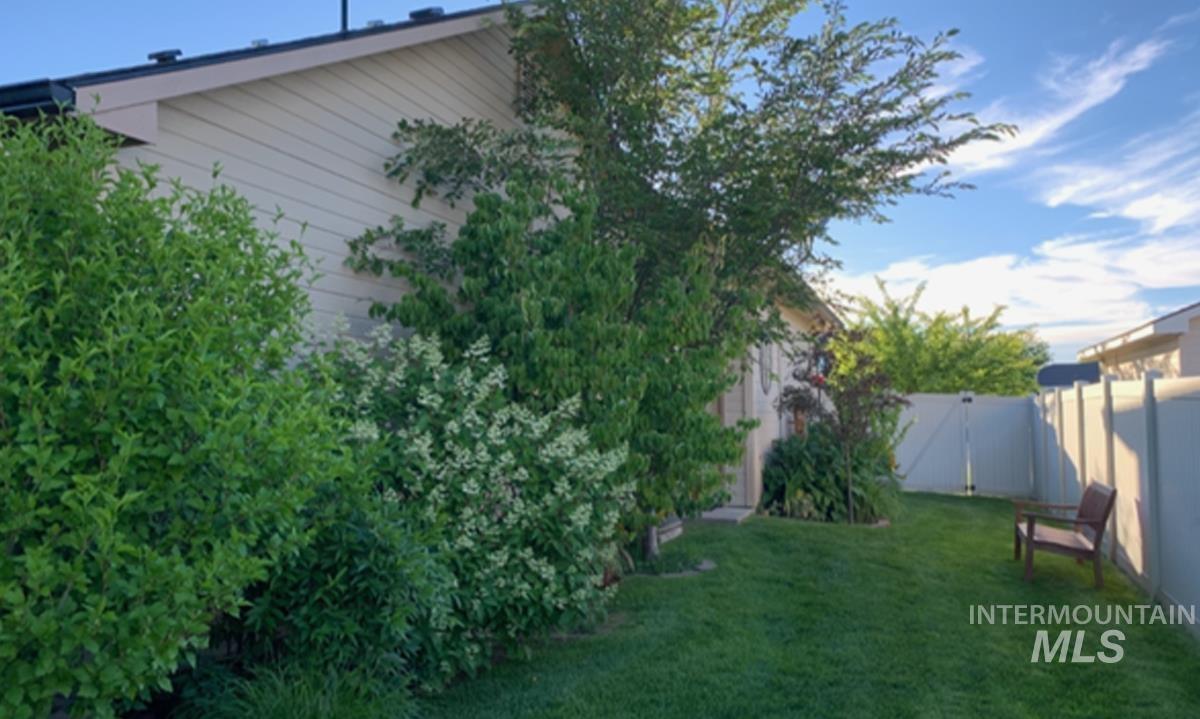 1513 Fairway Street Middleton, ID 83644 - Photo 20 of 20 View of side yard with a gate during the summer when all of the trees and landscaping are in full bloom.