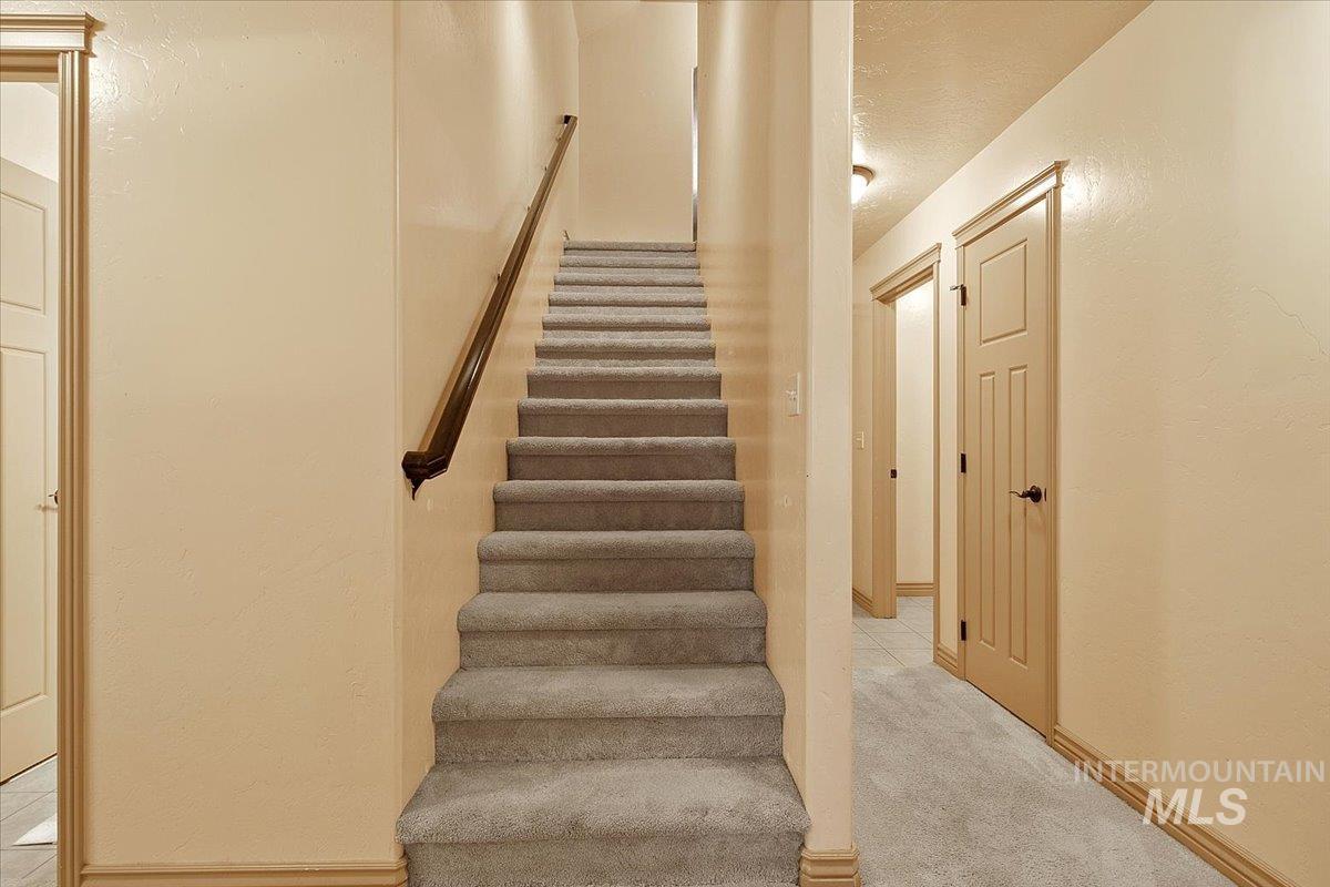 1513 Fairway Street Middleton, ID 83644 - Photo 9 of 20 Staircase featuring a textured wall and carpet flooring