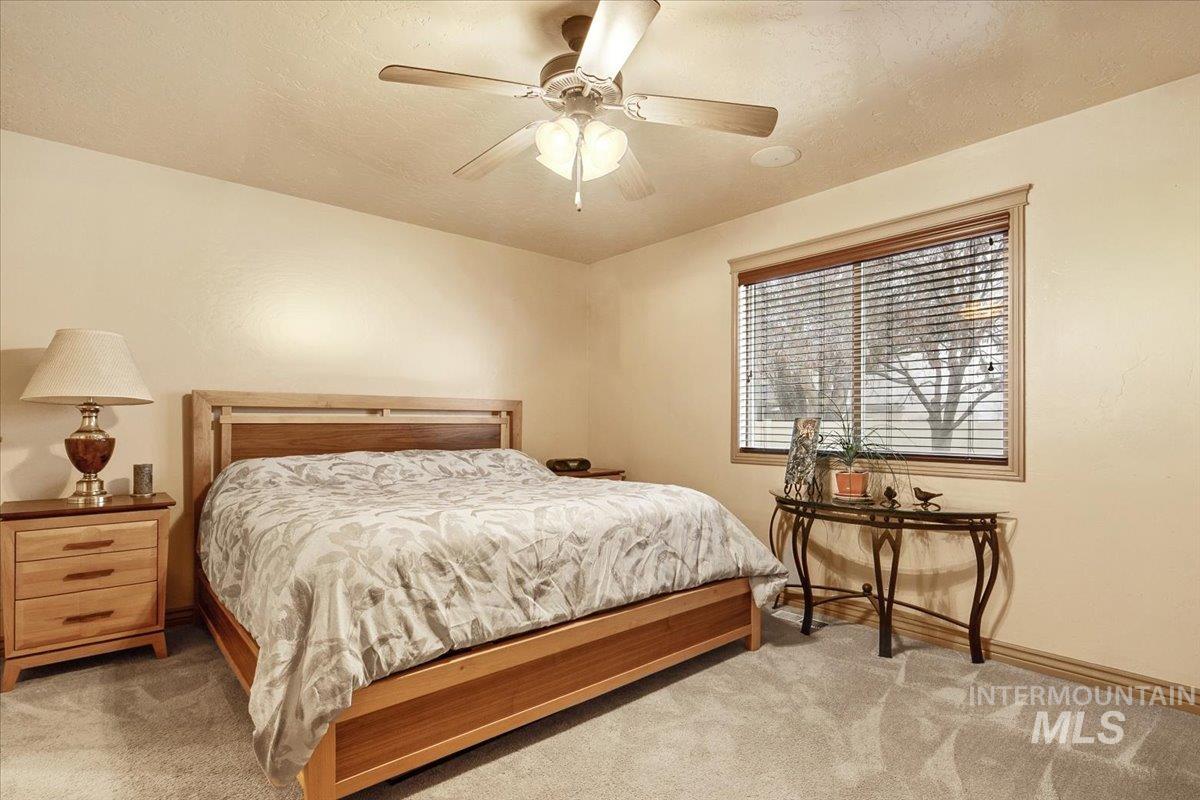 1513 Fairway Street Middleton, ID 83644 - Photo 10 of 20 Bedroom featuring ceiling fan, light colored carpet, and a textured ceiling