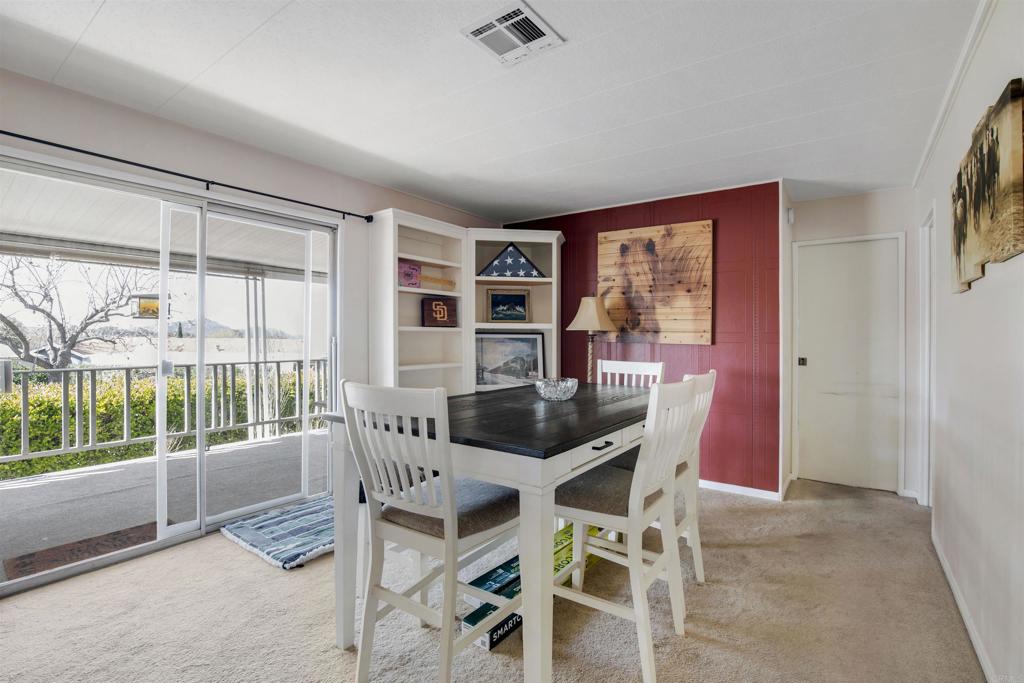 18218 Paradise Mountain Road Valley Center, CA 92082 - Photo 15 of 53 a dining room with furniture and large windows