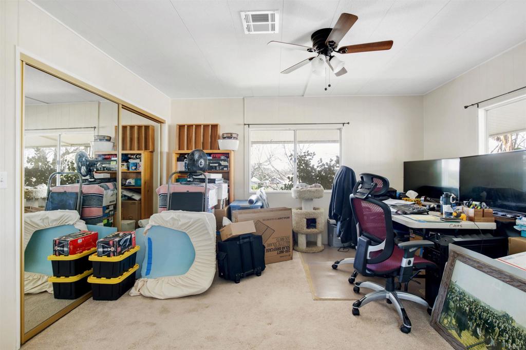 18218 Paradise Mountain Road Valley Center, CA 92082 - Photo 16 of 53 a view of a workspace with furniture and a window