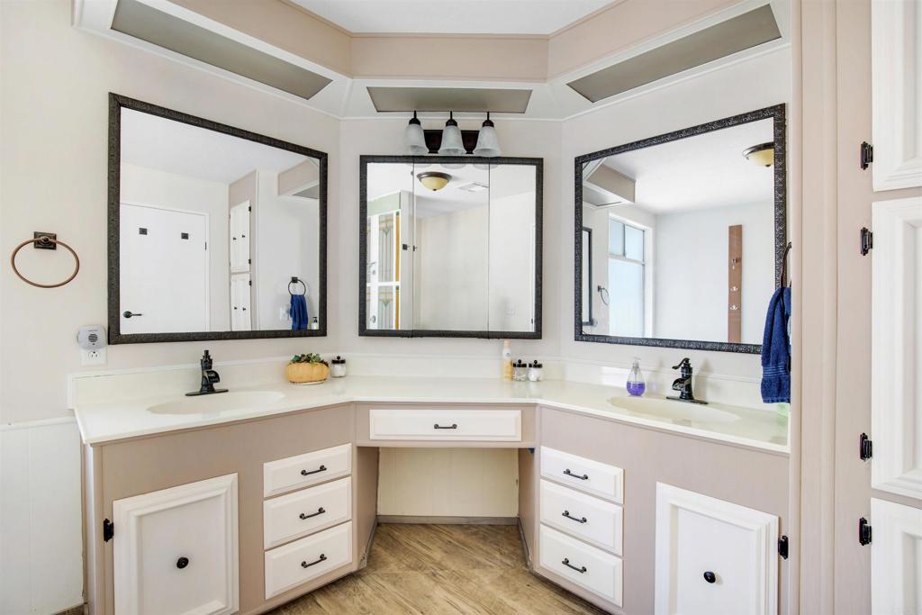 18218 Paradise Mountain Road Valley Center, CA 92082 - Photo 19 of 53 a bathroom with a double vanity sink and mirror