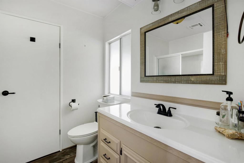 18218 Paradise Mountain Road Valley Center, CA 92082 - Photo 21 of 53 a bathroom with a toilet sink and mirror