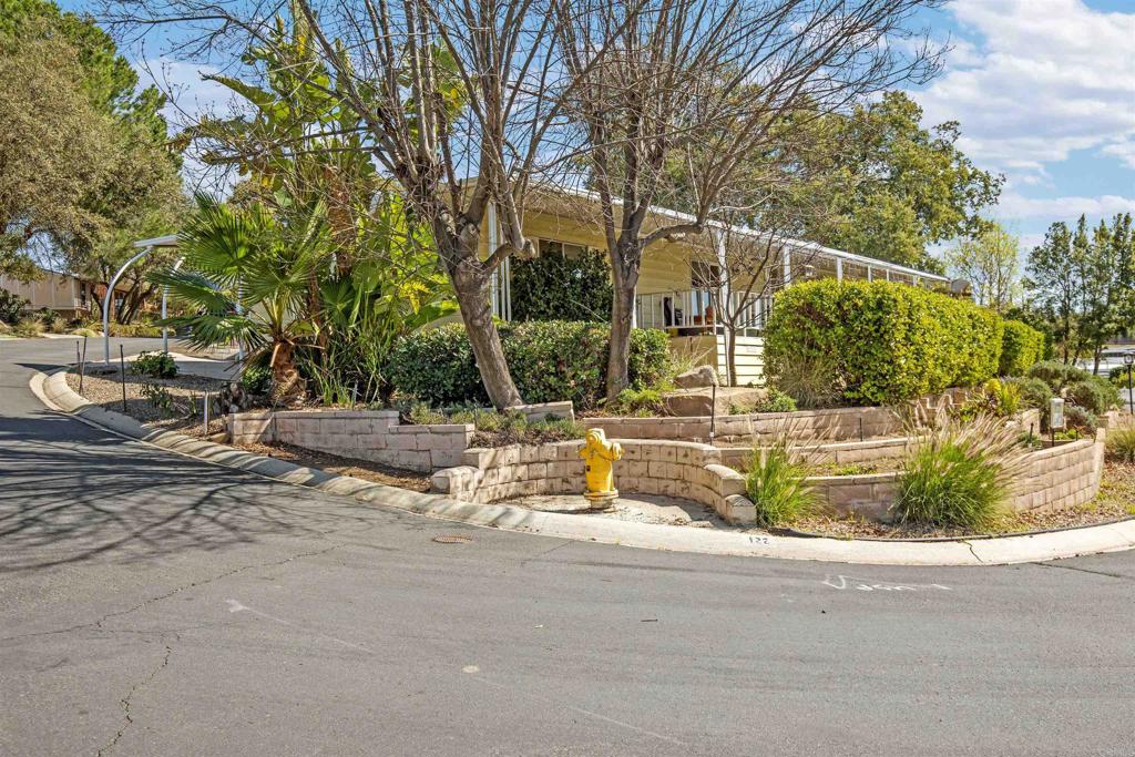 18218 Paradise Mountain Road Valley Center, CA 92082 - Photo 33 of 53 a backyard of a house with large trees and outdoor seating