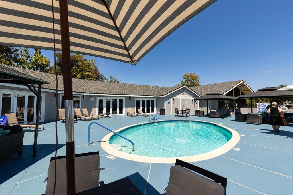 18218 Paradise Mountain Road Valley Center, CA 92082 - Photo 40 of 53 a view of a house with swimming pool and sitting area