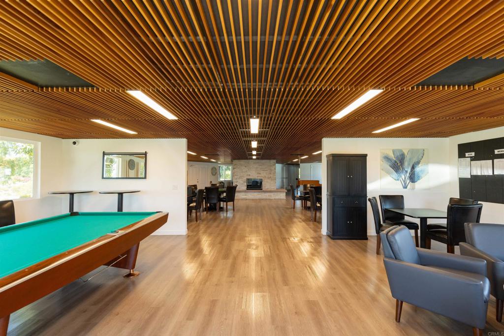 18218 Paradise Mountain Road Valley Center, CA 92082 - Photo 44 of 53 a living room with furniture pool table wooden floor and windows