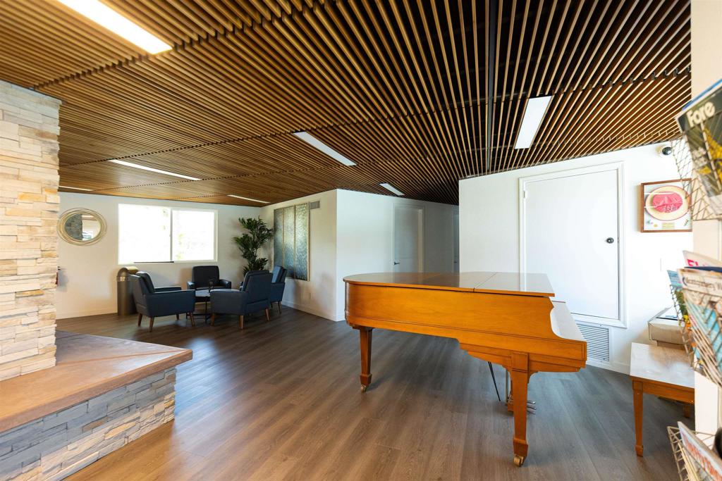 18218 Paradise Mountain Road Valley Center, CA 92082 - Photo 48 of 53 a living room with furniture a table and wooden floor