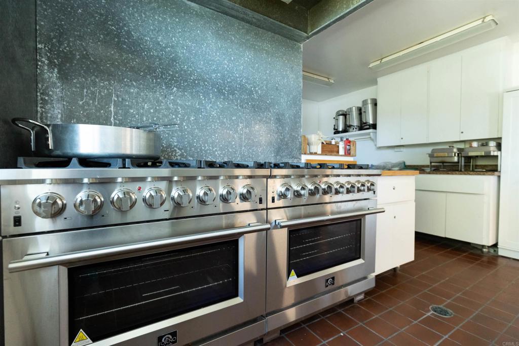 18218 Paradise Mountain Road Valley Center, CA 92082 - Photo 50 of 53 a stove top oven sitting inside of a kitchen