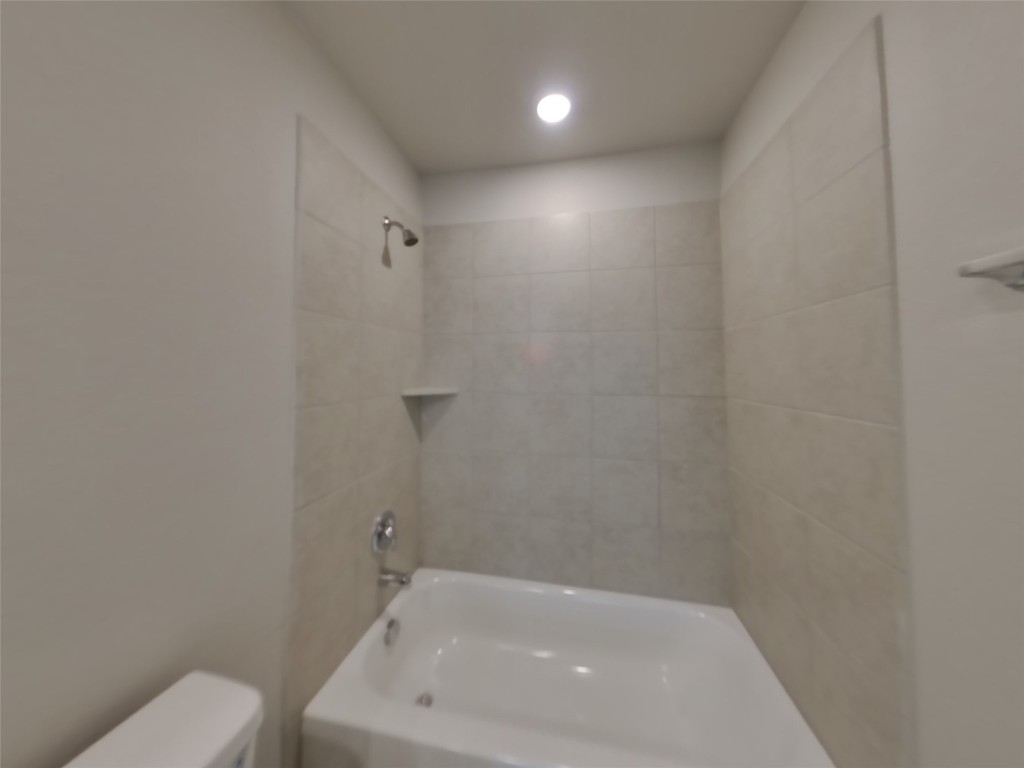 3504 Gooseneck Lane Georgetown, TX 78626 - Photo 13 of 27 a bathroom with a white bath tub and a toilet