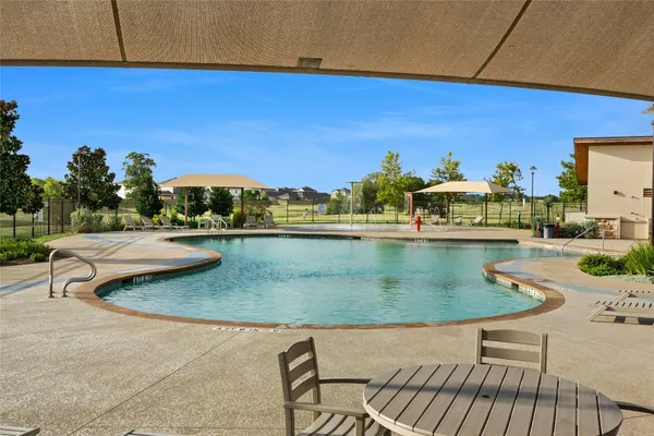 an outdoor space with furniture and umbrella