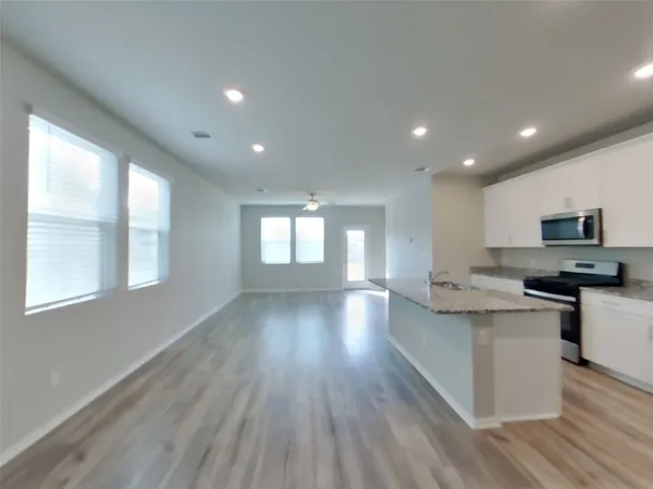 a view of kitchen with sink and wooden floor