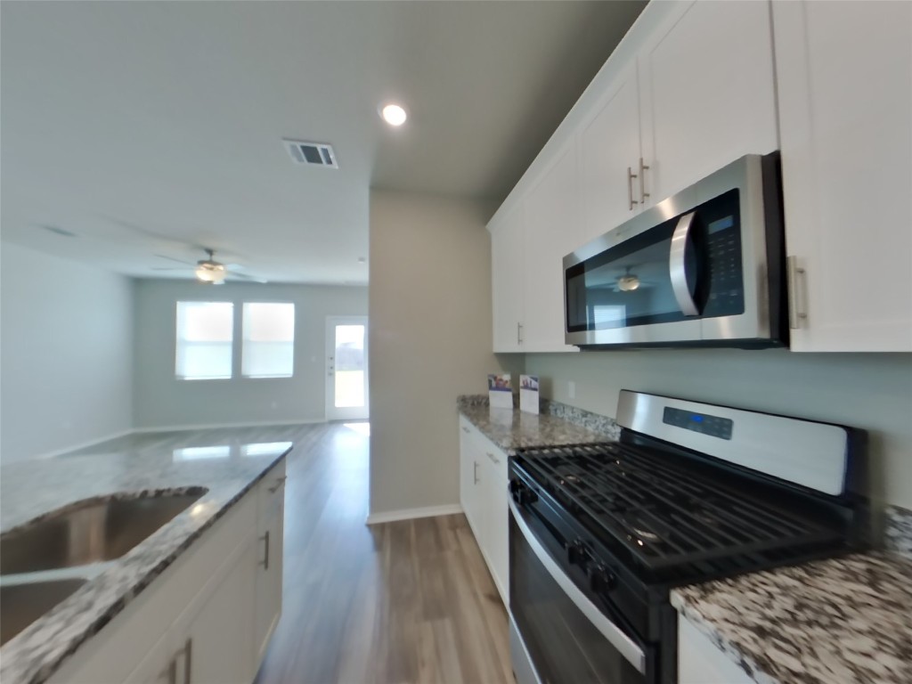 3504 Gooseneck Lane Georgetown, TX 78626 - Photo 5 of 27 a kitchen with a stove and a microwave