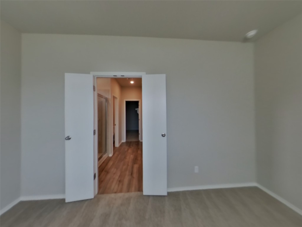 3504 Gooseneck Lane Georgetown, TX 78626 - Photo 6 of 27 a view of a hallway with wooden floor and closet