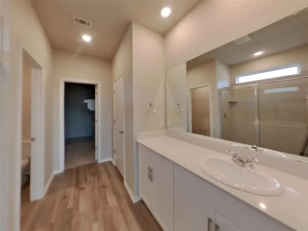a spacious bathroom with a double vanity sink and mirror