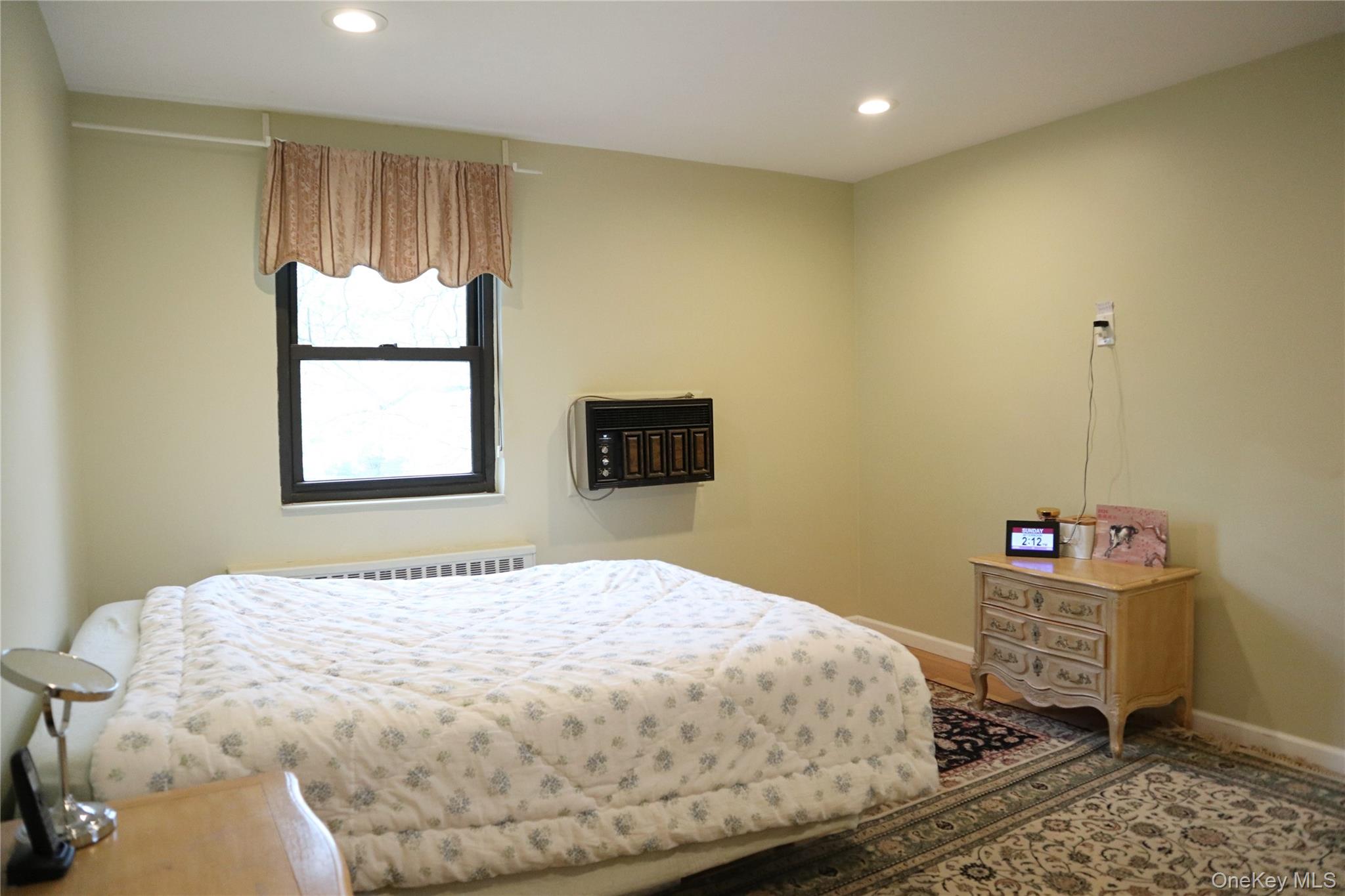 10 Terrace Circle, Unit 3B Great Neck, NY 11021 - Photo 6 of 8 a bedroom with a bed and wooden floor
