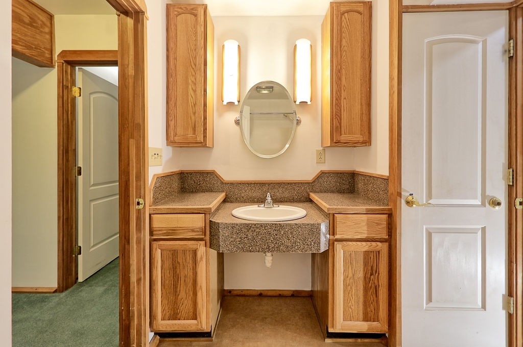 1053 Sam Johnson Road Columbia, TN 38401 - Photo 32 of 53 a bathroom with a granite countertop sink and a mirror