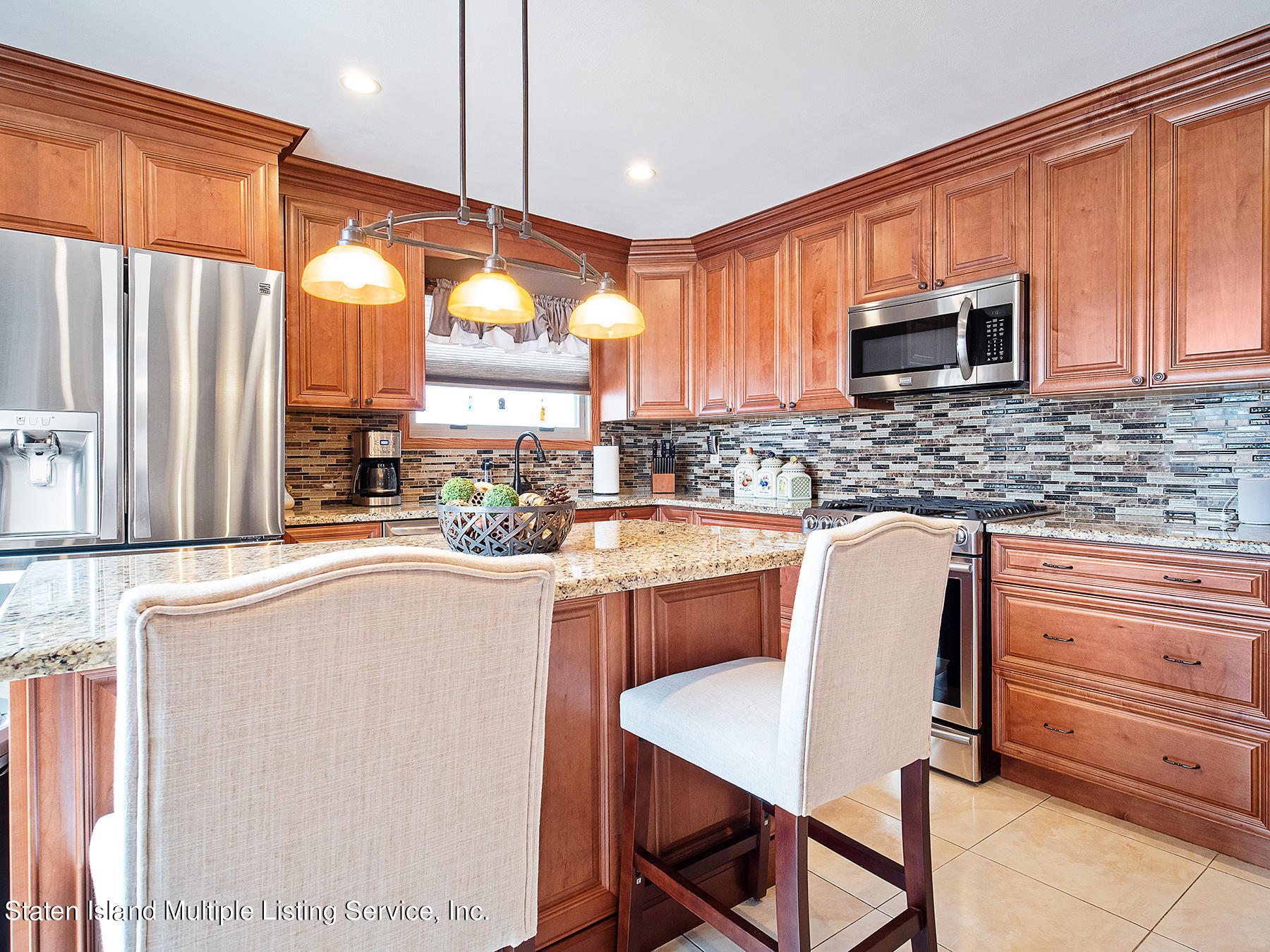84 Stack Drive Staten Island, NY 10312 - Photo 12 of 29 a kitchen with stainless steel appliances granite countertop a stove a sink and a microwave