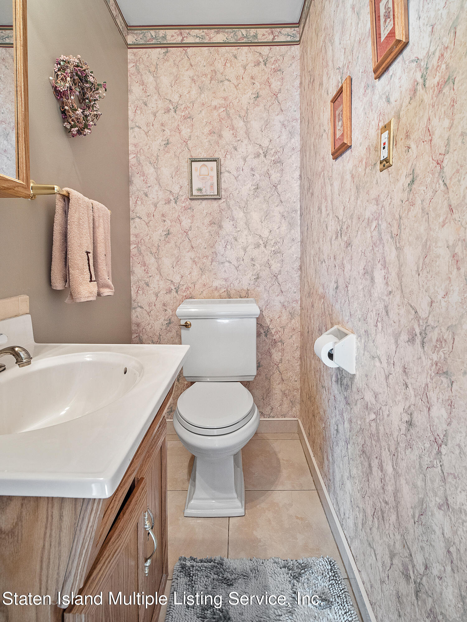 84 Stack Drive Staten Island, NY 10312 - Photo 14 of 29 a white toilet sitting next to a white sink