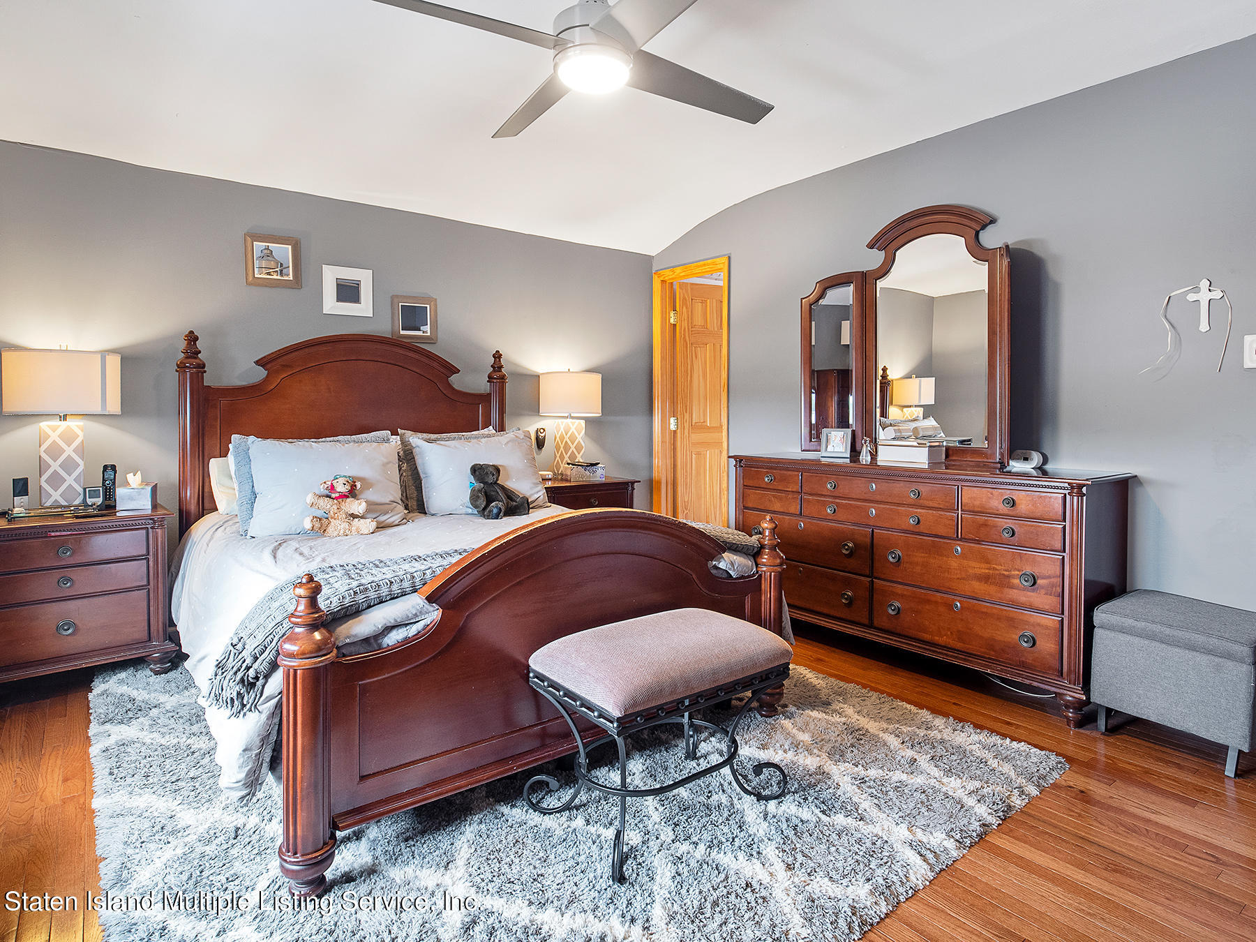84 Stack Drive Staten Island, NY 10312 - Photo 16 of 29 a bedroom with a bed and dresser with mirror