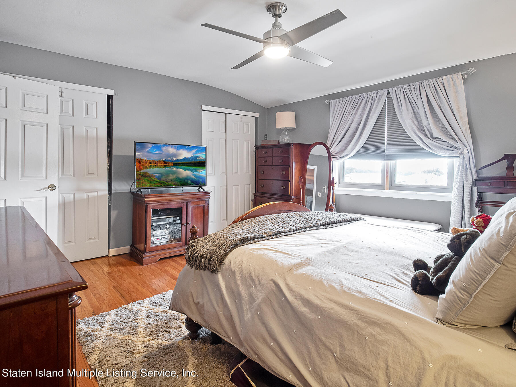 84 Stack Drive Staten Island, NY 10312 - Photo 17 of 29 a bedroom with a bed dresser and a window