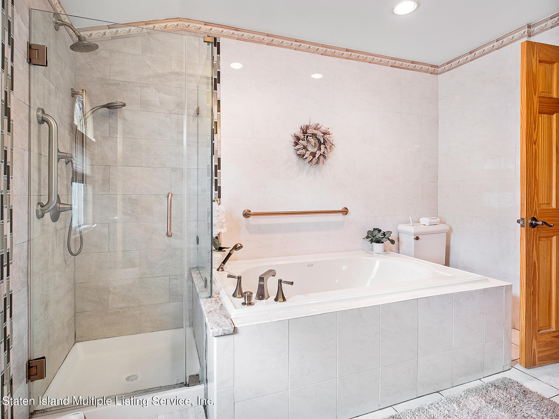 84 Stack Drive Staten Island, NY 10312 - Photo 18 of 29 a bathroom with a bathtub and a shower
