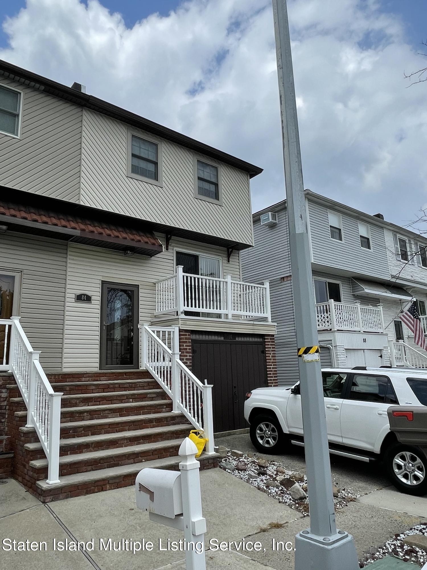 84 Stack Drive Staten Island, NY 10312 - Photo 2 of 29 a front view of a house with parking space