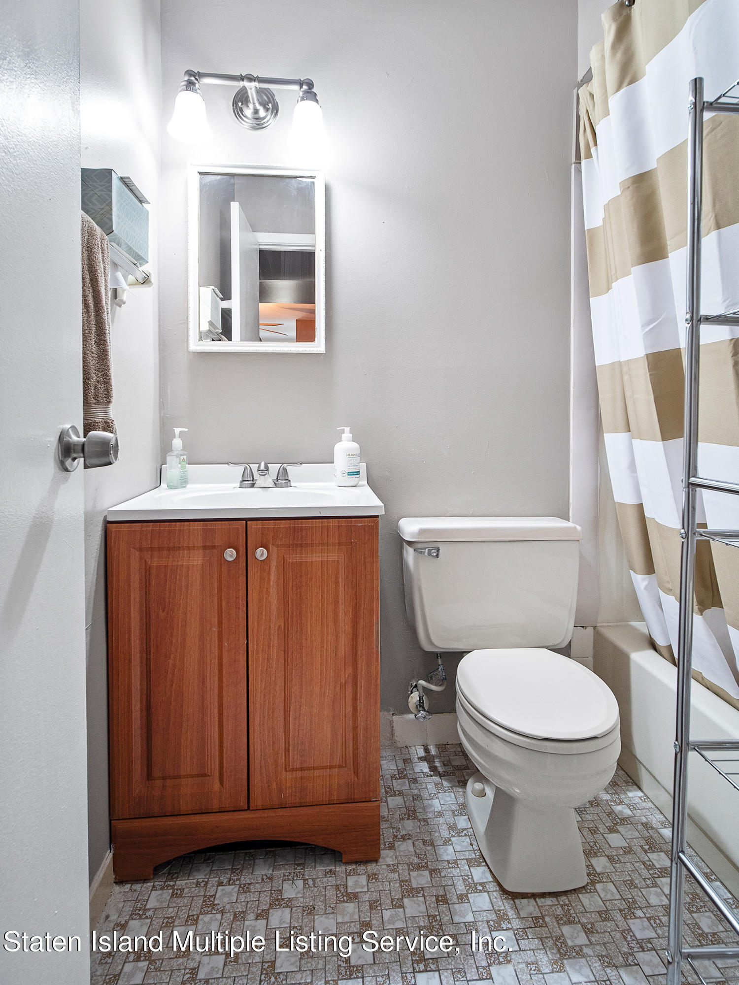 84 Stack Drive Staten Island, NY 10312 - Photo 24 of 29 a bathroom with a toilet a sink and a mirror