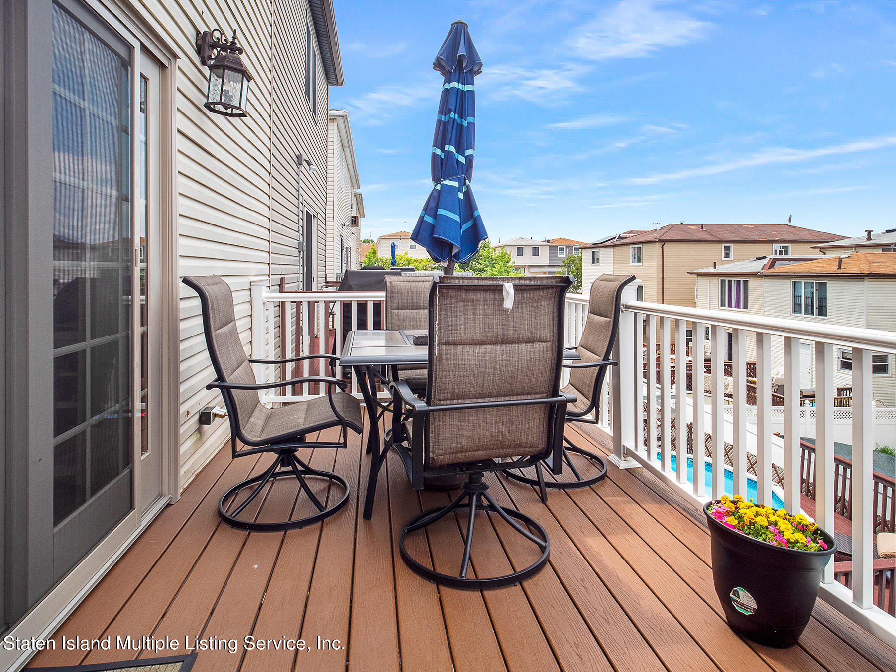 84 Stack Drive Staten Island, NY 10312 - Photo 25 of 29 a view of a balcony with chairs and wooden floor