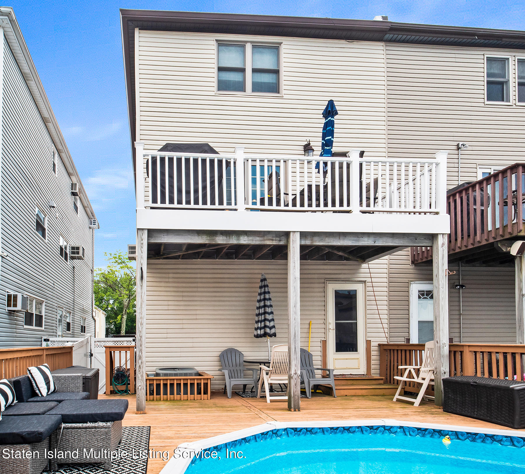 84 Stack Drive Staten Island, NY 10312 - Photo 27 of 29 a view of a house with lounge chairs in patio