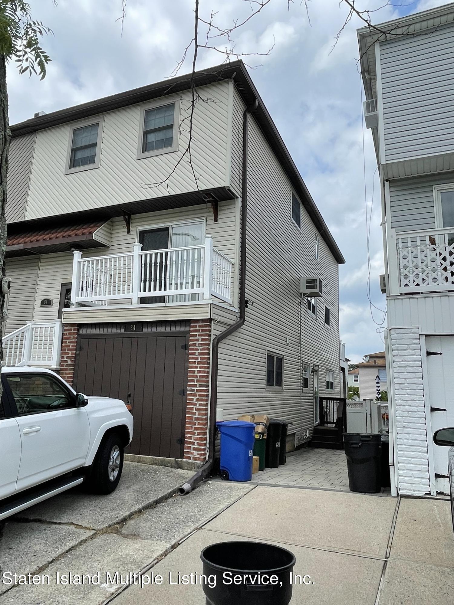 84 Stack Drive Staten Island, NY 10312 - Photo 3 of 29 a view of a car park in front of house