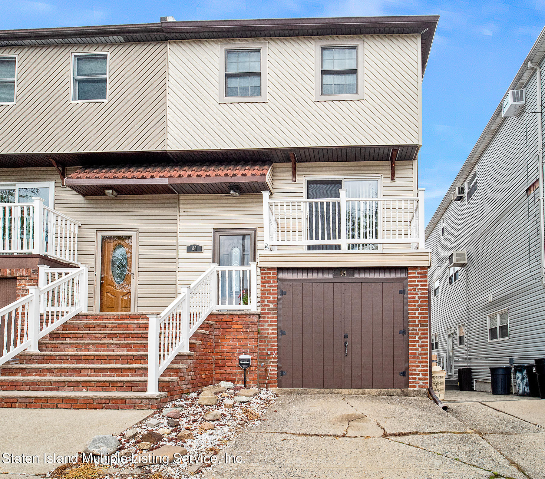 84 Stack Drive Staten Island, NY 10312 - Photo 4 of 29 a front view of a house with a garage
