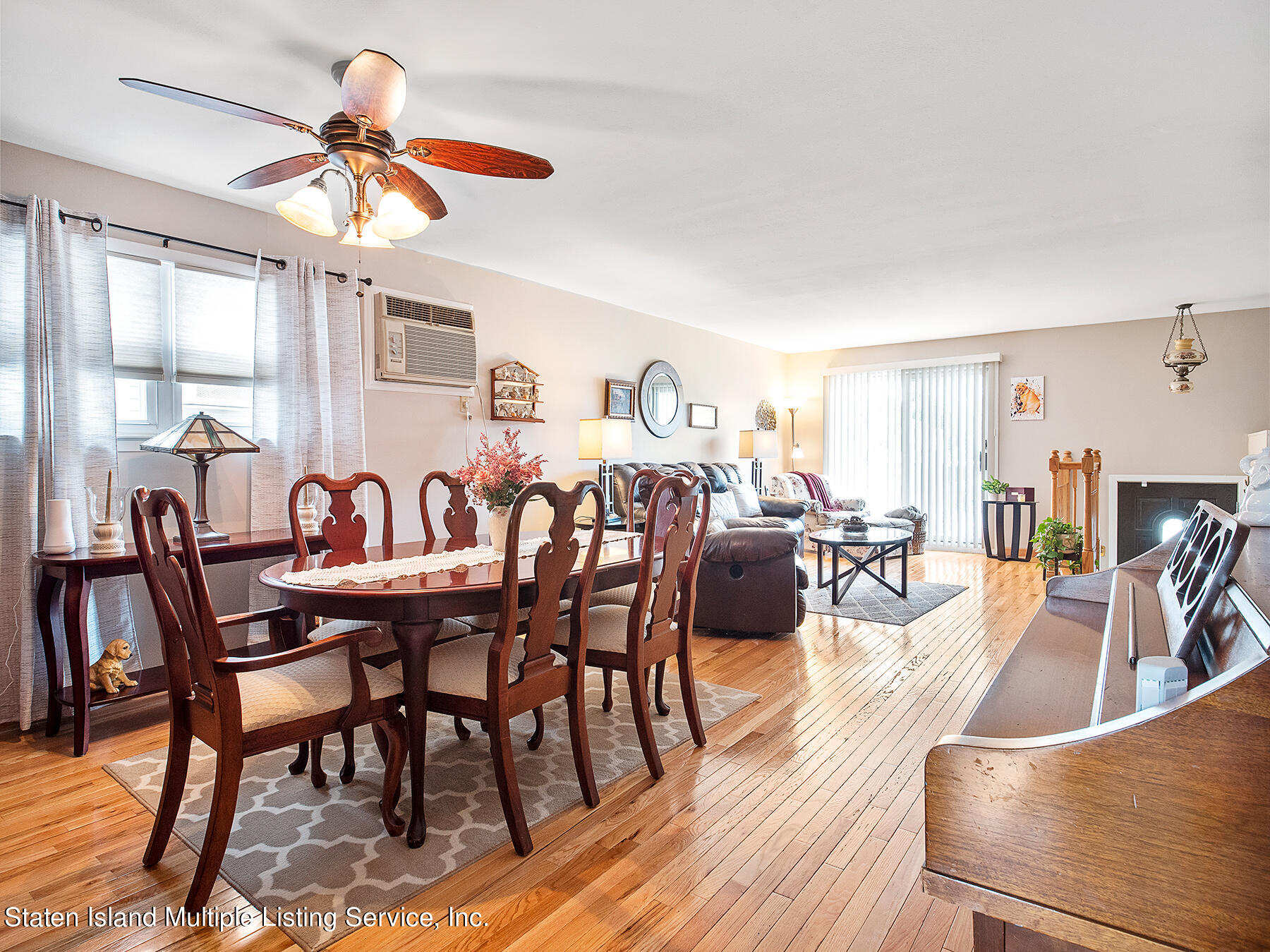 84 Stack Drive Staten Island, NY 10312 - Photo 10 of 29 a dining room with furniture a chandelier and wooden floor