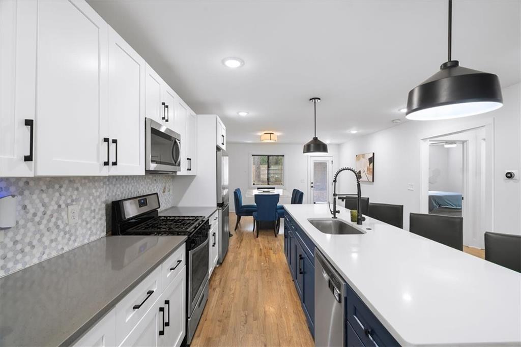 1846 Rogers Avenue Southwest Atlanta, GA 30310 - Photo 14 of 46 a kitchen with counter top space cabinets and stainless steel appliances